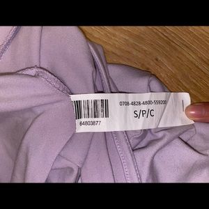 small purple crop top with opening in the back